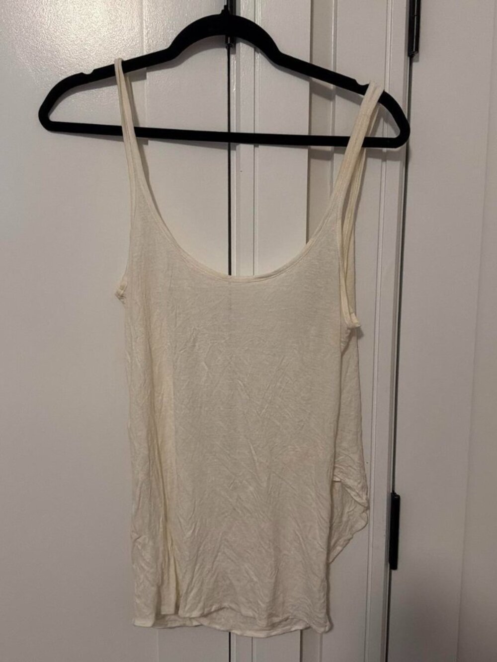 Cream tank top with subtle textured pattern and low back
